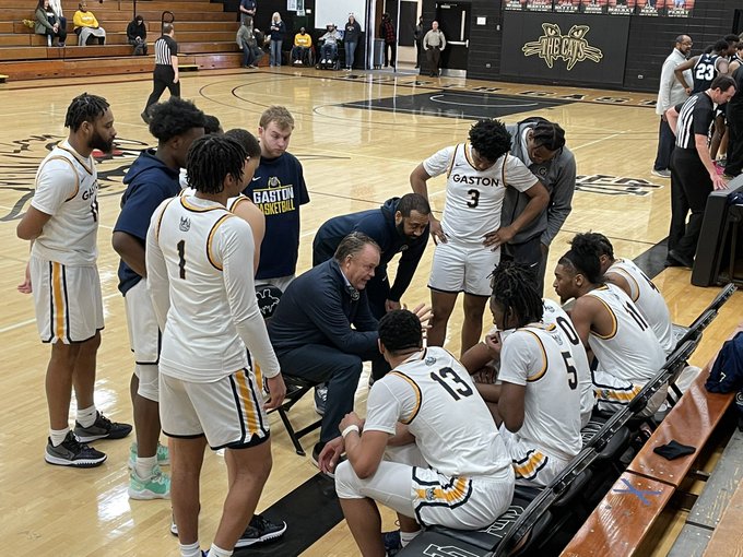 Gaston College's David "Dickey" Nutt (center) addresses his team during a huddle during the 2021-22 season.