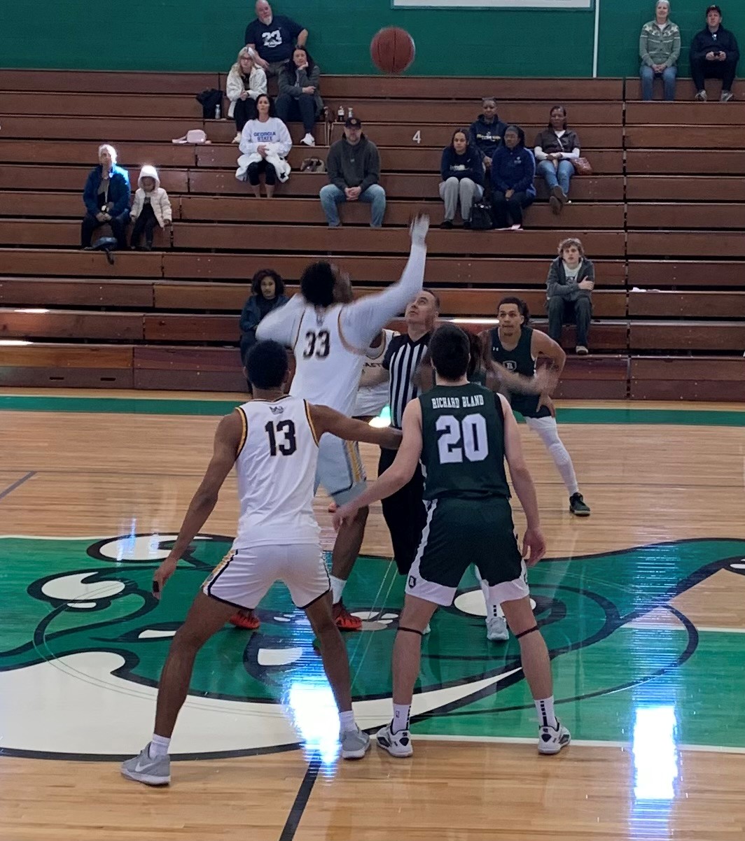 Gaston College sophomore Kaleb Siler (33) goes after game-opening jump on Saturday at Gastonia's Ashbrook High School gymnasium.