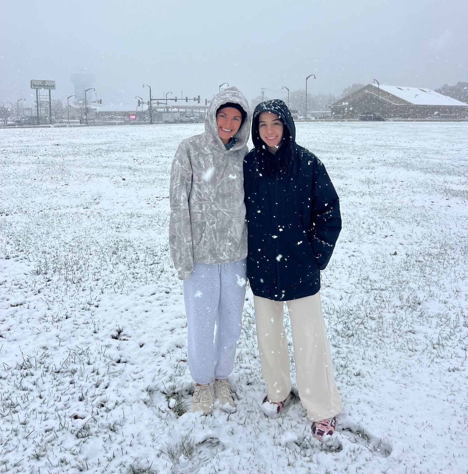 Gaston College's Lexi Birtwistle (left) and Maddie Frank competed on a snowy course during the 2025 NJCAA national cross country championships.